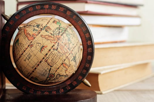 Globe and books on floor of library.