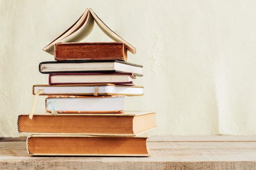 Old book stack on a wooden floor.