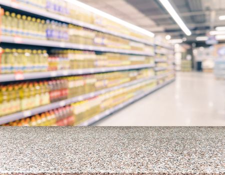 Marble board empty table in front of blurred supermarket - can be used for display or montage your products. Mockup for display of product.