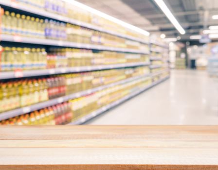 Light wooden board empty table in front of blurred background. Perspective light wood over blur in supermarket - can be used for display or montage your products. Mockup for display of product.