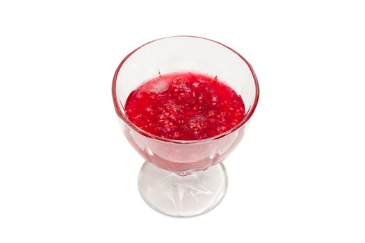 Raspberry jam in the glass dessert stem bowl on a light background
