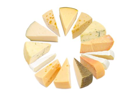 Different pieces of hard cheese, semi-soft cheese and soft cheese various types lined up in a circle on a light background
