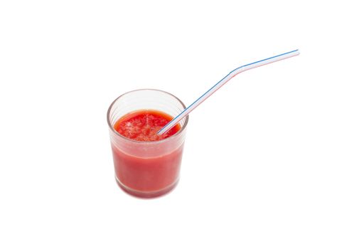 Tomato juice in glass with bendable drinking straw on a light background
