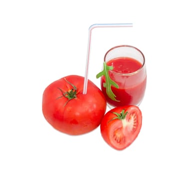 Big fresh whole tomato with bendable drinking straw inserted into it, half of the tomato and glass with tomato juice and arugula leaf on a light background
