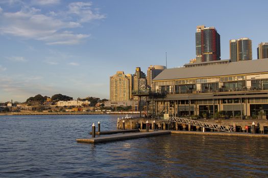 Sydney, Australia - June 24, 2017: The historical Jones Bay Wharf office and restaurant building in Sydney Australia with the CBD skyscrapers in the background.
