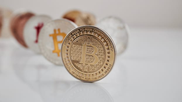 Digital currency physical gold bitcoin coin on white table.
