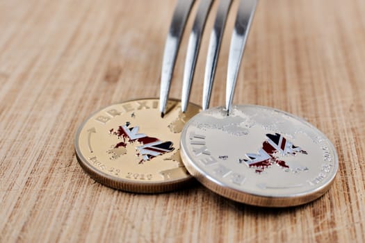Physical brexit coin on the wooden board. Europe leaving concept.