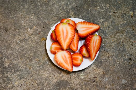 Delicious strawberry in home cooking on wooden table, black background.