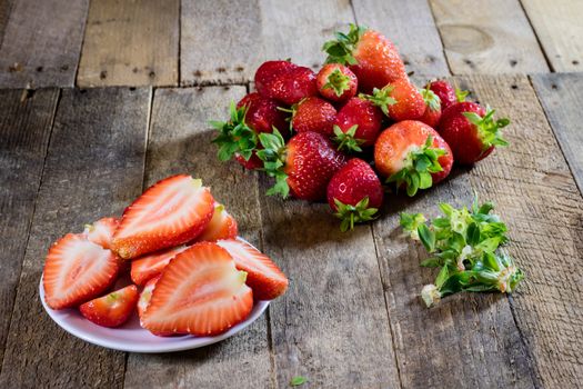 Delicious strawberry in home cooking on wooden table, black background.