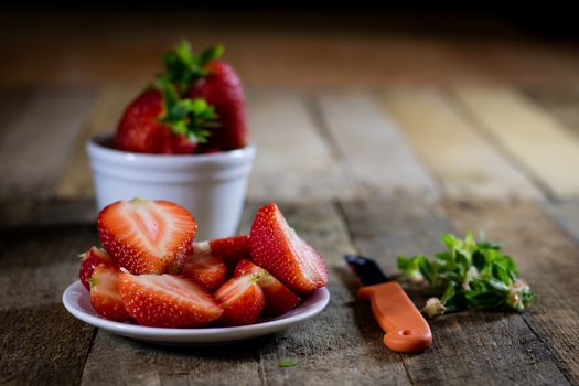 Delicious strawberry in home cooking on wooden table, black background.