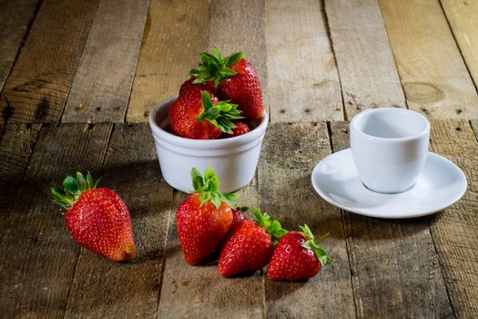 Delicious strawberry in home cooking on wooden table, black background.