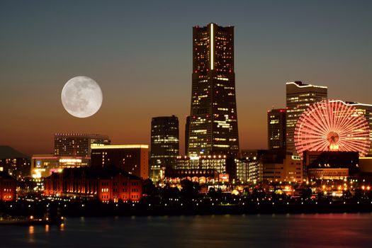 Urban Landscape Yokohama, Japan skyline with full moon at dusk