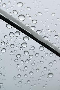 Macro rain water droplets on clear plastic umbrella in vertical frame