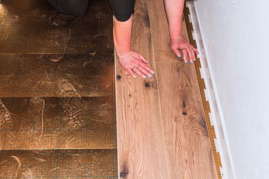 Woman in the laying of plastic laminate or vinyl
