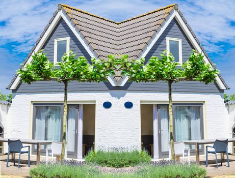 Beautiful holiday house complex with terrace in front of a blue sky