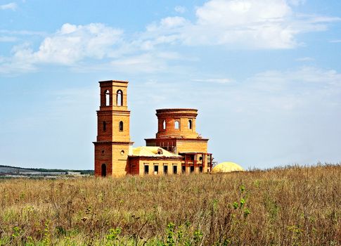 Abandoned unfinished Christian temple in the countryside on a spring day.