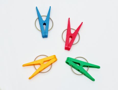 Four plastic clothes pegs isolated on white background.
