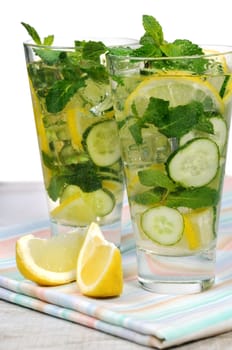 Refreshing cocktail cucumber mojito with lemon slices and mint