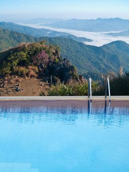 Outdoor swimming pool on top of mountain with mist