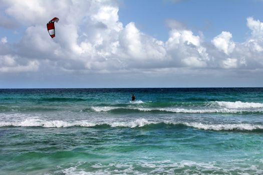 Kiteboarder enjoy surfing in water. 
