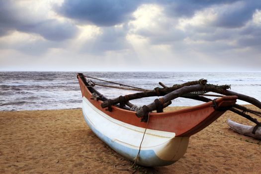 Fishing boat on a deserted coast. Sri Lanka (Ceylon)