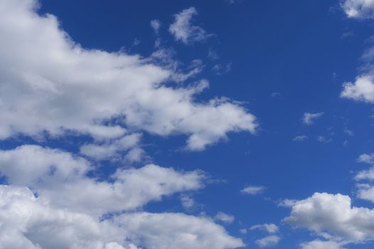 White big clouds in a bright blue sky close-up