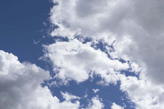 White big clouds in a bright blue sky close-up