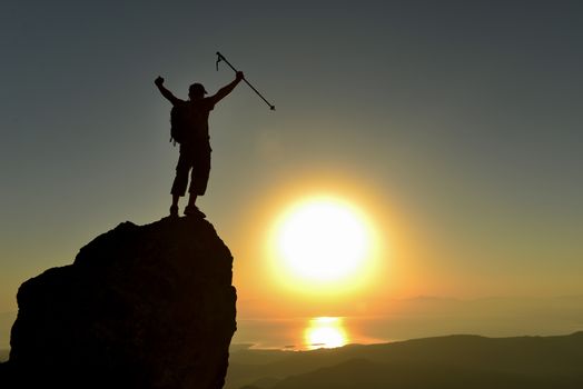 successful climber on the cliff