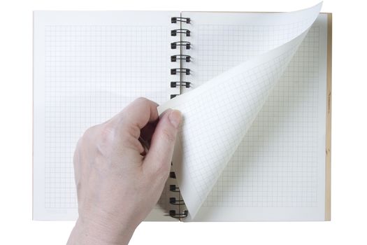 Hand turns the notebook page on white background