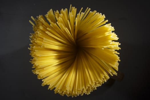 Beam of Italian pasta on a black background