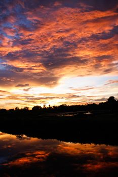 orange sky reflect on canal in evening