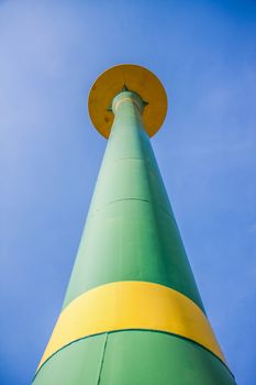 green public water tank hold up to blue sky