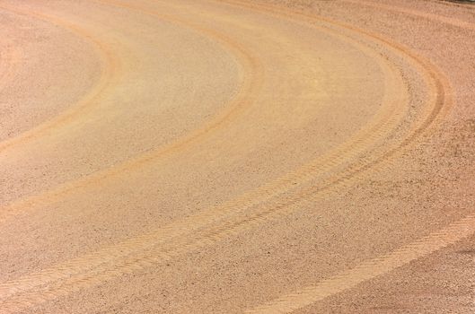 curve tire track on orange athletics, soil and sand