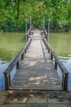 walkway wooden bridge over pond on park of silpakorn university, Nakhonpathom