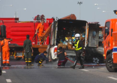 Firefighter fire brigade small truck car crash on motorway street, blur