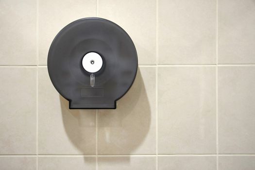 Paper Holder box hanging in tile wall in toilet