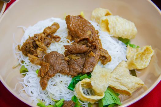 noodles soup with vegetable chicken, fried pork skin,  rice noodle on bowl