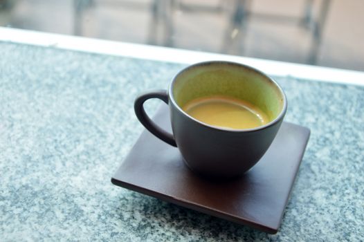 hot espresso coffee in brown Ceramic Cup on Marble counter. coffee morning ready for drink in the morning coffee time.