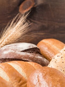 Close up view of differnet bread on brown wooden background. Copy space. Shallow DOF. Vertical.