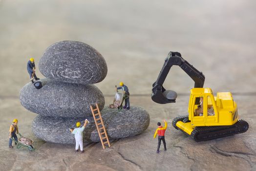 Pebbles stack and workers figurines