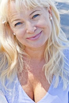 vertical portrait of blond woman in sunlight