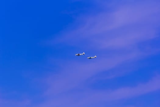Photo of two flying planes in blue sky