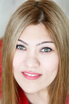 Attractive smiling young girl with straight hair and green eyes