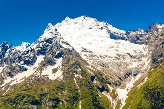 Photo of landscape with Russian Caucasus rockies with blue sky