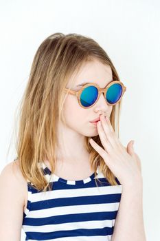 Cute girl eleven years old  in green sunglasses on white
