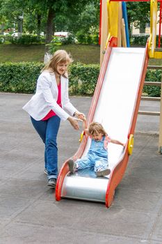 Mother with baby girl riding on hutches with screw up one eyes