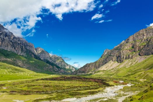Summer picturesque landscape with Russian Caucasus rockies mountains and blue sky