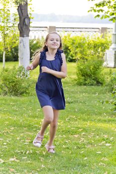 Cute running girl with disheveled hair in green park