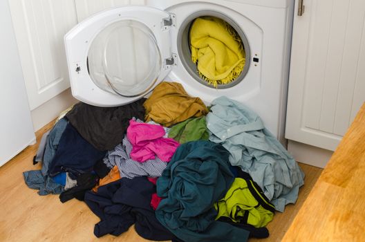 Washing machine, colorful clothes. Pile of laundry.