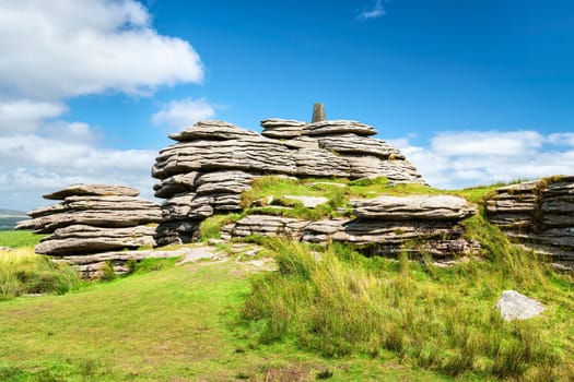 View of Bellever Tor in Dartmoor national park in southwest England. Copy space in blue sky.